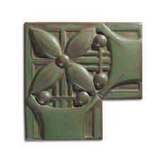 two green tile tiles with flowers and leaves on the sides, one is made out of metal