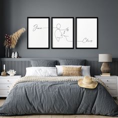 a bedroom with two pictures hanging above the bed