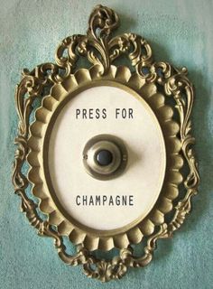 there is a sign on the wall that says press for champagne and it's attached to a hook