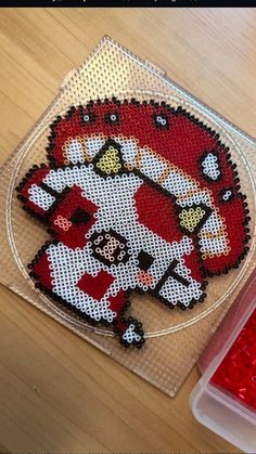 a hello kitty bead kit sitting on top of a wooden table