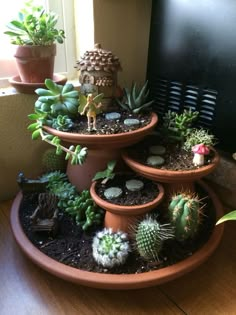 three tiered planters filled with succulents and plants