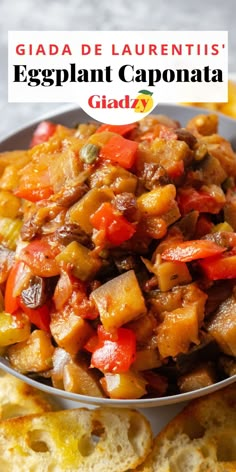 an eggplant caponata is served in a bowl with bread on the side