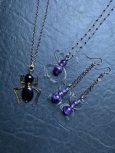 "Creepy crawly friends just in time for spooky season! Whether you love spiders or abhor them, these will add a little bit of whimsy to your day. Genuine polished amethyst spheres wrapped in gunmetal wire to create these little crawlies! Necklace is paired with a beautifully wirewrapped gemstone necklace, using tiny faceted black spinel wrapped in silver wire, closing with a sterling silver lobster claw clasp. This necklace sparkles like a silky starry spider web. Earrings are suspended from hyp Handmade Jewelry For Halloween Party, Handmade Halloween Party Jewelry, Spooky Black Jewelry Gift, Purple Halloween Jewelry Gift, Gothic Purple Jewelry Gift, Witchy Jewelry For Halloween Jewelry Making, Handmade Dangle Halloween Jewelry, Handmade Dangle Necklaces For Halloween, Handmade Witchy Necklace For Party