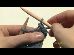 someone crocheting the ends of a piece of yarn with a wooden knitting needle