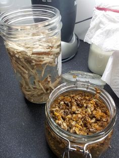 two jars filled with food sitting on top of a counter