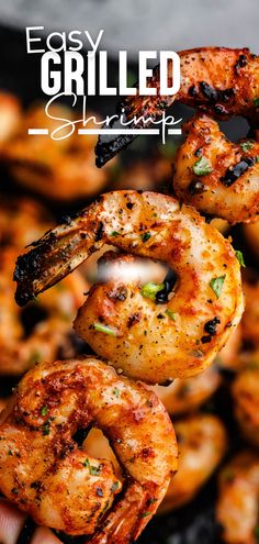 A skewer of grilled curly shrimp with the tails on being held above a pan of skewered shrimp. Shrimp On Bbq Grill, Marinate Shrimp For Grilling, Grill Shrimp Recipes, Blackstone Shrimp Recipes, Simple Grilled Shrimp, Marinate Shrimp, Shrimp On The Grill, Grilling Shrimp, Cooking Raw Shrimp