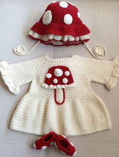 two crocheted knitted baby clothes, one with a red hat and the other with white polka dots