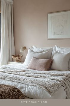 a bed with white linens and pillows in a bedroom next to a large window