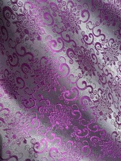 purple and silver wallpaper with an intricate design