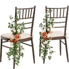 two chairs decorated with flowers and greenery for a wedding or special event, side by side