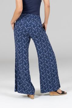 Why We Love This: Experience stylish comfort on your travels with our Blue Vines Portofino Pants. Crafted from lightweight and breathable fabric, these wide leg pants feature a charming blue vines pattern, convenient side pockets, and a comfortable smocked waistband for a perfect fit. Whether you're exploring new destinations or lounging by the beach, these pants offer effortless style and travel-ready convenience.. Features: KiraGrace TravelDream fabric with stretch Functional side pockets Feels luxuriously smooth, soft, light, and breathable High-rise, 31" inseam (fits 30"-33"). Leg Opening: 32" Comfortable, figure flattering smocked waistband Waist: High-rise (11.5" Rise) Inseam: 31" inseam (fits 30"-33"), easily modified Leg Shape: Flowy wide leg Sizing: True to size Compression: Flowy Vines Pattern, Travel Pant, Travel Pants, By The Beach, Yoga Tops, Comforters Cozy, Tight Leggings, Soft Light, Tops For Leggings