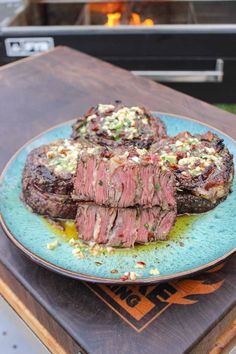 steak is served on a blue plate with sauce