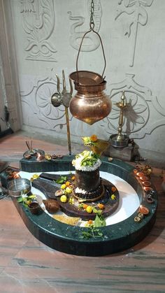 a table topped with a cake on top of a plate next to a potted plant