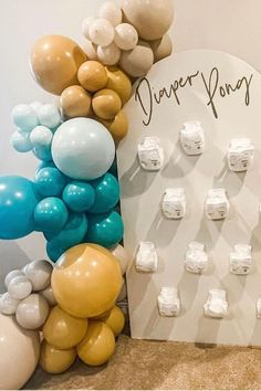 there is a sign with balloons on it next to a wall that says happy honey