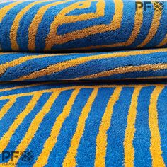 blue and yellow rugs stacked on top of each other