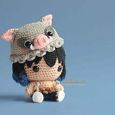 a crocheted doll is posed as a pig