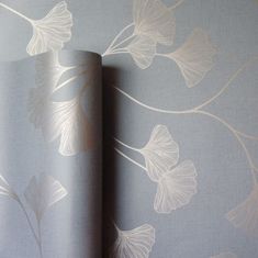 the wall paper is designed with leaves and vines on it's side, as well as an image of a flower