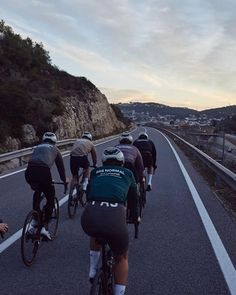 a group of people riding bikes down a road