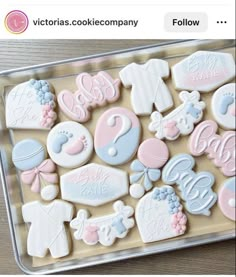 a tray filled with lots of cookies covered in icing