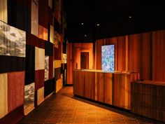 a room with wooden walls and tiled floors