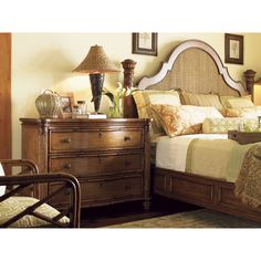 a bed sitting next to a dresser in a bedroom