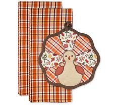 two napkins with an embroidered turkey on the front and plaid pattern in the back