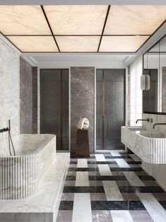 a bathroom with marble walls and black and white checkered floor