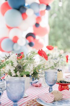 the table is set with red, white and blue decorations