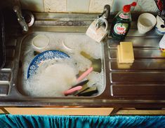 a sink filled with soap and toothbrushes