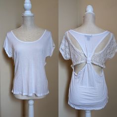 By One Step Up, Size Large All White Tee Material And White Lace. Back Has A Horizontal Lace Panel Which Transitions To Sleeves. The Back Tee Shirt Material Forms Racer-Back Over The Lace And Has A Knot Cinching The Middle In. About A 36 Inch Bust And 22 Inches From Shoulder To Bottom Hem. New Without Tags, Never Worn. Comes From A Smoke Free Home. Scoop Neck Stretch Top For Daywear, Stretch Scoop Neck Top For Daywear, Spring Daywear Tops With Scoop Neck, Fitted Lace Top T-shirt For Summer, Scoop Neck Spring Tops For Daywear, Scoop Neck Tops For Spring Daywear, Stretch Crew Neck Top For Daywear, Stretch Scoop Neck Tops For Day Out, Short Sleeve Stretch Lace Top