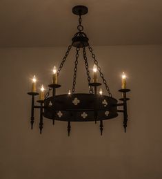 a chandelier with five lit candles hanging from it