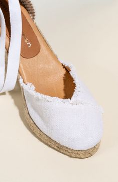 A breathable linen upper and frayed trim bring a mix of earthy textures to a handcrafted espadrille finished with wide laces that wrap up and around the ankle. 3" heel; 3/4" platform Wraparound ankle strap with tie closure Cushioned footbed Textile upper/leather lining/rubber sole Made in Spain White Textile Espadrilles For The Beach, White Textile Espadrilles For Beach, White Textile Espadrilles For Vacation, White Textile Espadrilles For Summer, Spring White Textile Espadrilles, Summer Wedge Heel Espadrilles With Textured Sole, White Espadrilles With Textured Sole For Summer, Beach Lace-up Textile Espadrilles, Summer Jute Espadrilles With Round Toe