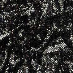 You might almost expect a face to appear in the magically mirror-like brightness of this Milly Italian Black and Reflective Silver Paillette Sequins on Black Stretch Velour! A luxuriously soft black velvet knit holds an array of two-colored sequins—metallic black on one face and reflective quicksilver on the other—stitched so that they can flip back and forth to show off both colors. With a slight four-way stretch, greater through the weft, and a malleable drape, create sleek, form-hugging dress Glamorous Black Sequin Fabric, Black Sparkling Sequin Fabric For Night Out, Black Sparkling Sequin Fabric For Glamorous Style, Black Glitter Sequin Fabric For Night Out, Black Sequin Glitter Fabric For Night Out, Black Sequin Fabric With Glitter For Night Out, Black Sparkling Sequin Fabric For Evening, Glamorous Black Sequin Fabric With Glitter, Black Sparkling Sequin Fabric For Party Season