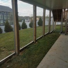 an enclosed area with grass and fenced in areas for animals to roam around the yard