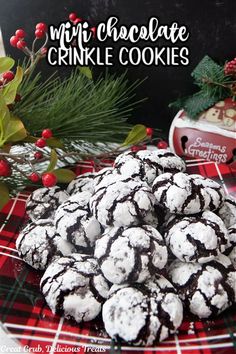 chocolate crinkle cookies on a plate with holly and pine cones in the background