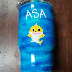 a blue can with a yellow shark on it and the words asa painted on it