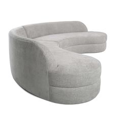 a large grey couch sitting on top of a white floor next to a chair and ottoman