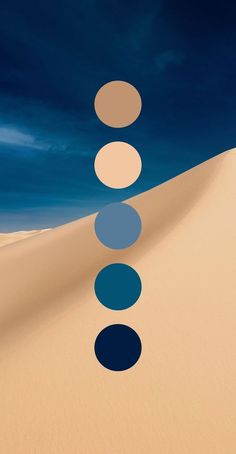 an image of a desert scene with circles on the sand and blue sky in the background