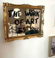 a mirror with the words the work of art is you written on it