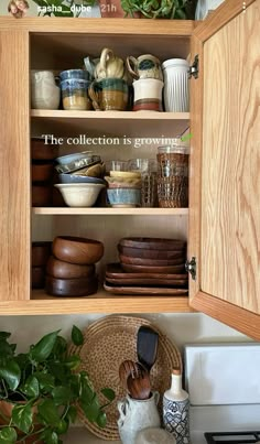 a kitchen cabinet filled with lots of dishes and pots on top of a white counter