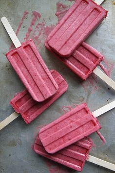 three popsicles are sitting on top of a table