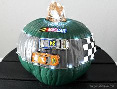 a car themed pumpkin sitting on top of a black table next to a white wall