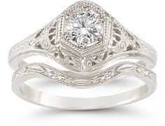 a white gold engagement ring set with an old - fashioned style diamond in the center