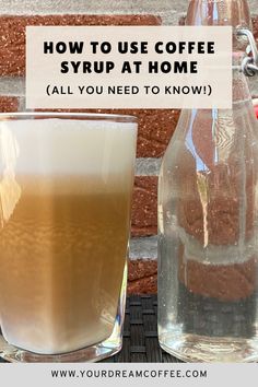 two bottles and a glass filled with liquid sitting next to each other