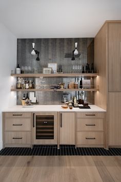 a kitchen with wooden cabinets and shelves filled with bottles, wine glasses and other items