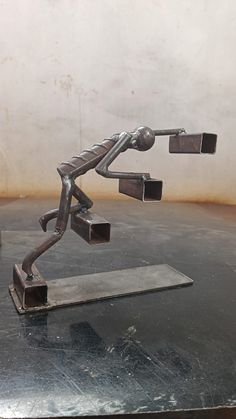 a metal sculpture sitting on top of a table