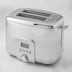 a silver toaster sitting on top of a white counter