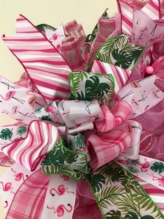 a close up of a pink and white bow with flamingos on it's side