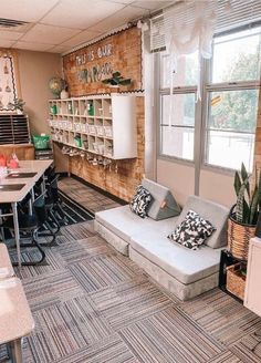 a room with couches, tables and shelves on the wall next to each other