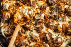 a casserole dish with meatballs and cheese on top, in a cast iron skillet